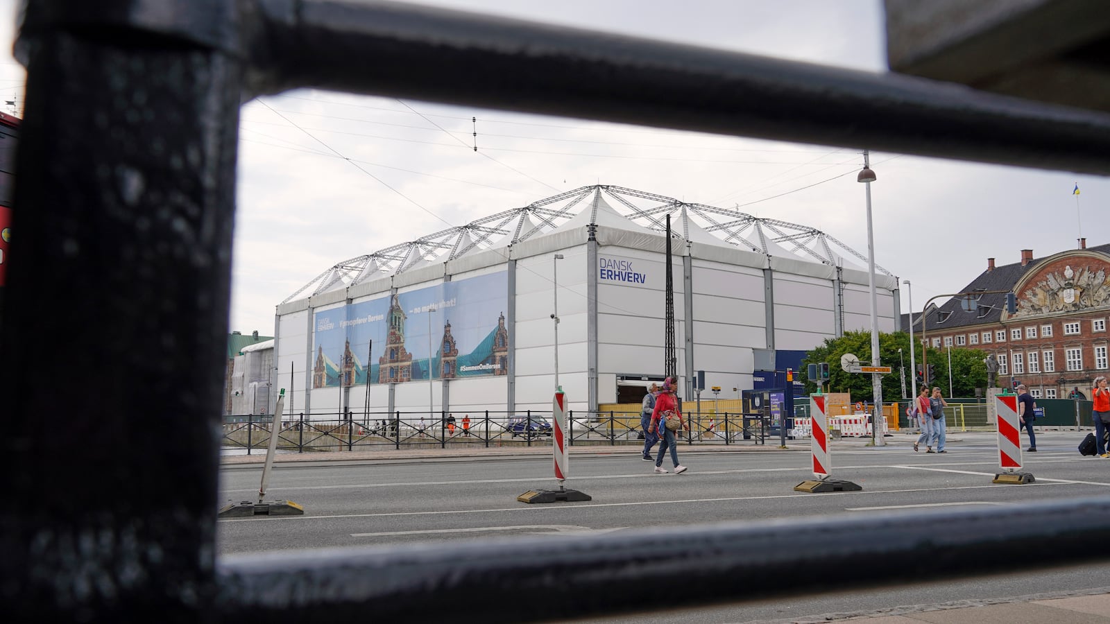 The fire-damaged Old Stock Exchange building is shrouded by a white construction tent in Copenhagen, Denmark, Monday, June 23, 2025. (AP Photo/James Brooks)