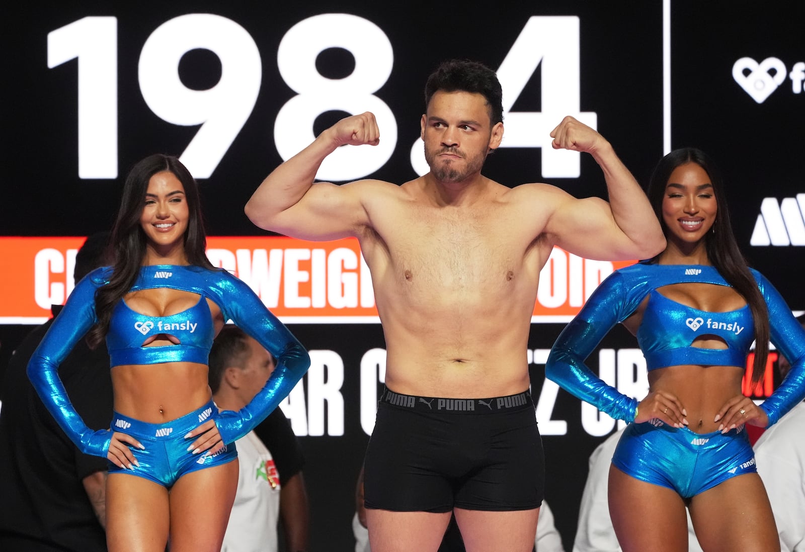 Julio Cesar Chavez Jr., center, poses during a weigh-in ahead of his cruiserweight boxing match against Jake Paul, Friday, June 27, 2025, in Anaheim, Calif. (AP Photo/Chris Pizzello)