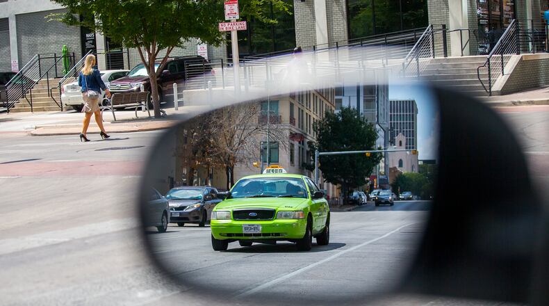 An ATX Coop Taxi is travels on 3rd St in downtown Austin on Wednesday, June 13, 2018. RICARDO B. BRAZZIELL / AMERICAN-STATESMAN