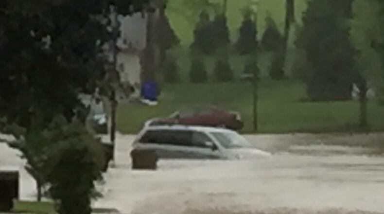 A Hamilton resident had to be rescued Wednesday night after heavy rains swept up her green Honda Odyssey on between Tabor and Cleveland avenues. CONTRIBUTED