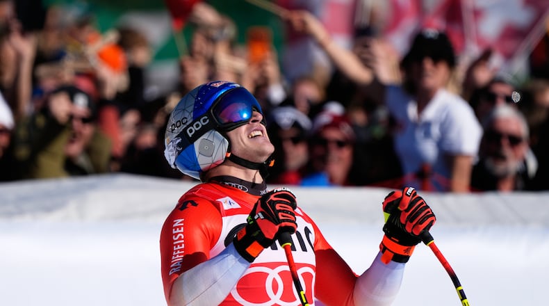 Switzerland's Marco Odermatt reacts at the finish area, during a men's World Cup downhill race, in Garmisch Partenkirchen , Germany, Saturday, Feb. 28, 2026. (AP Photo/Giovanni Auletta)