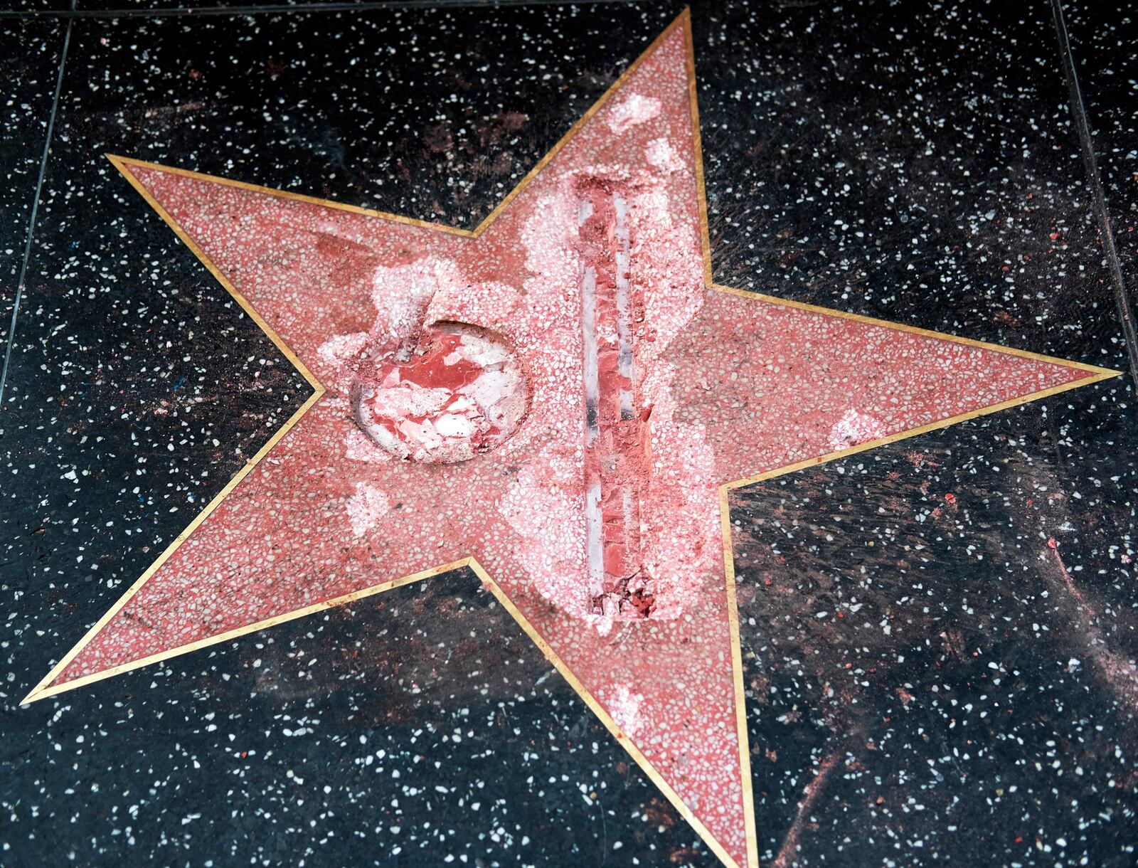 FILE - This Oct. 26, 2016 file photo shows the vandalized Hollywood Walk of Fame star of then-presidential candidate Donald Trump. An attorney for James Lambert Otis, who admitted causing the damage, says he pleaded no contest to felony vandalism Tuesday, Feb. 21, 2017. He was sentenced to three years of probation, 20 days of community labor and to pay $4,400 for the damage. (AP Photo/Richard Vogel, File)