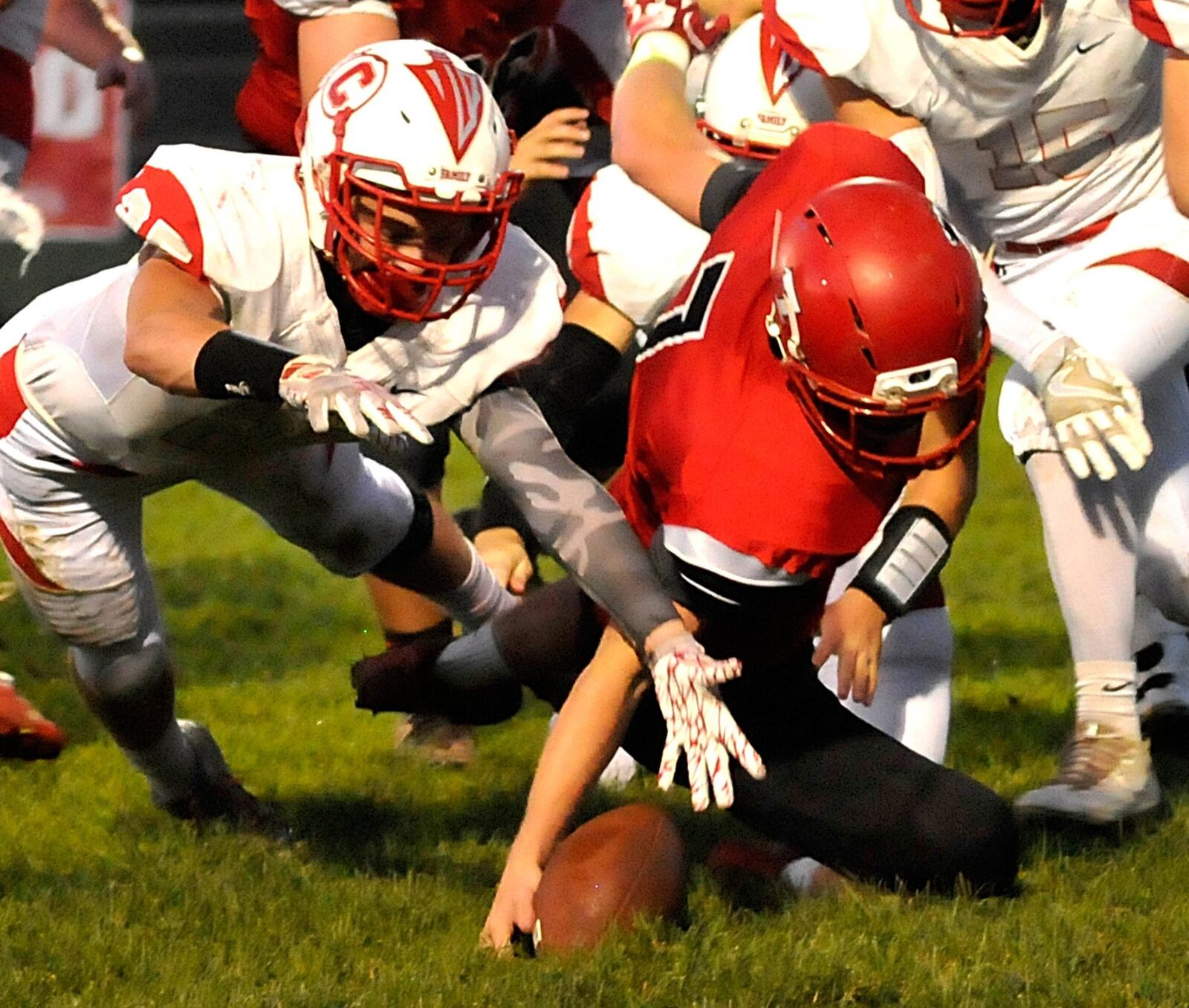 Madison quarterback Mason Whiteman (7) recovers his own fumble during Friday night’s game against visiting Carlisle at Brandenburg Field. CONTRIBUTED PHOTO BY DAVID A. MOODIE