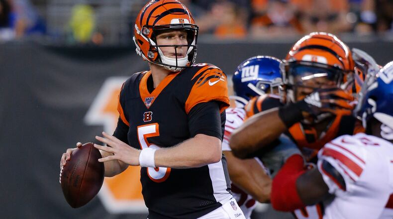 FILE - In this Aug. 22, 2019, file photo, Cincinnati Bengals quarterback Ryan Finley (5) looks to pass during the first half of an NFL preseason football game against the New York Giants, in Cincinnati. The winless Bengals benched Andy Dalton heading into their bye week, ending his nine-season run as starter so they can start developing rookie Ryan Finley as his potential long-term replacement. The move came two days after a 24-10 loss to the Rams in London left Cincinnati 0-8 for the first time in 11 years. (AP Photo/Frank Victores, File)