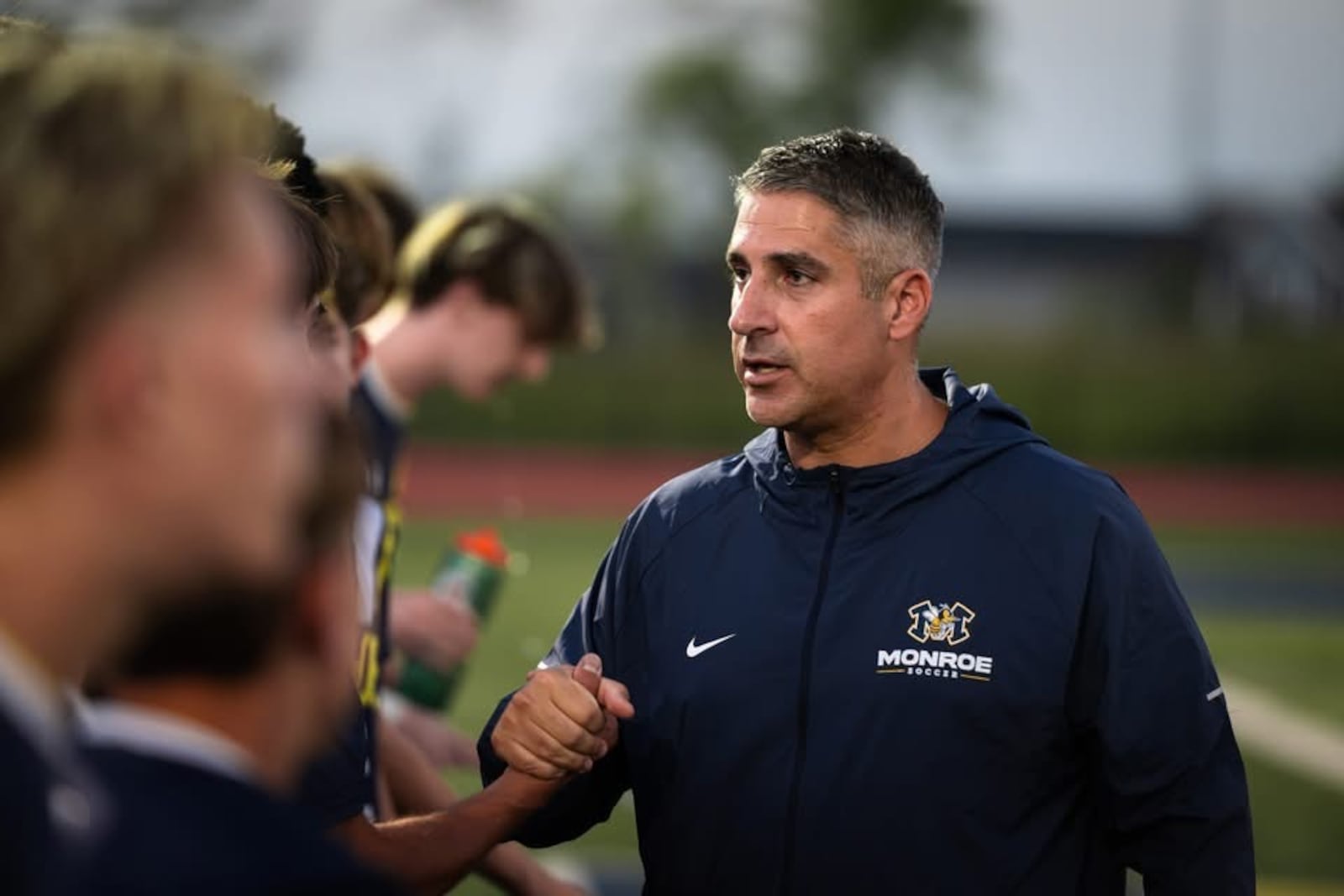 Monroe boys soccer coach Billy Gronostaj embraces a player during a recent game. AJ FULLAM / CONTRIBUTED