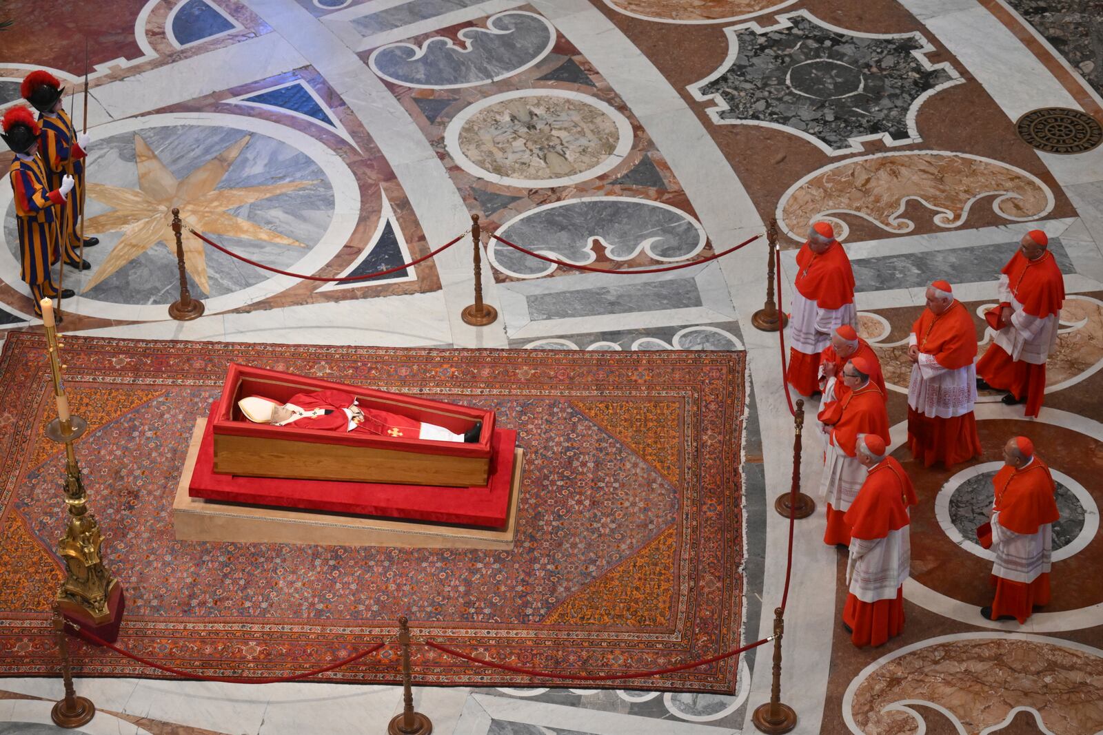 Cardinals pay their respects to late Pope Francis inside St. Peter's Basilica at the Vatican, Wednesday, April 23, 2025, where he will lie in state for three days. (Alessandro Di Meo/Pool Photo via AP)
