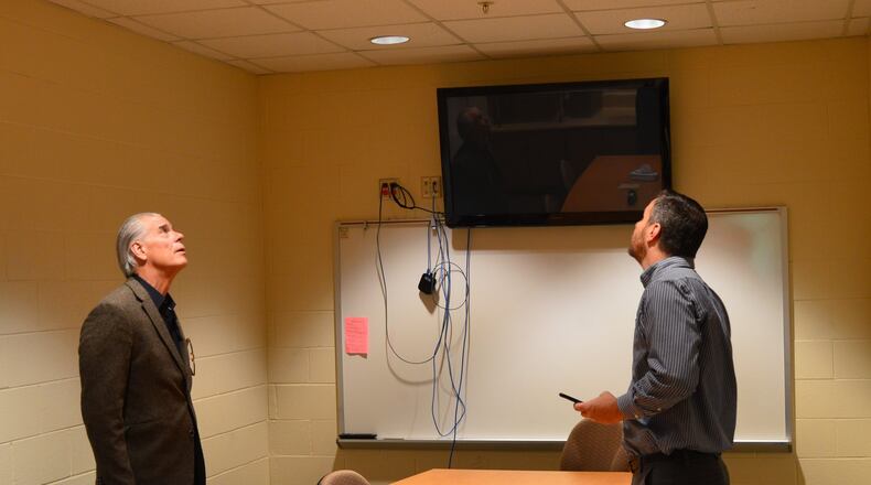 Jason Brown, of Heapy Engineering, right, talks to Talawanda District Treasurer and CFO Mike Davis about the LED lighting in Bogan Elementary following an energy efficiency retrofit at the school. CONTRIBUTED/BOB RATTERMAN