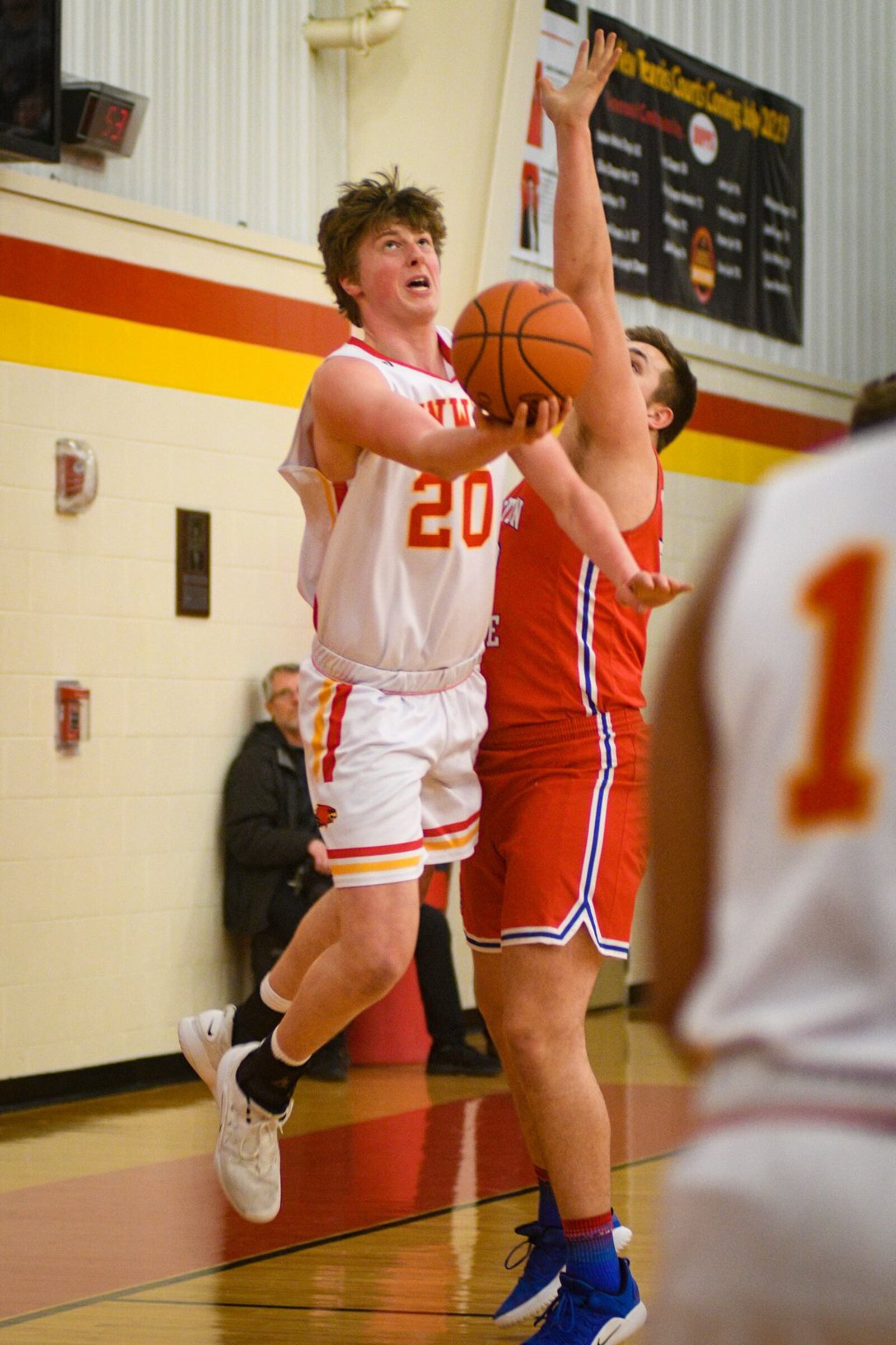 Fenwick’s A.J. Braun (20) makes a move toward the basket during Monday night’s game against Clinton-Massie at Fenwick. The host Falcons won 67-48. ROB MCCULLEY/RAM PHOTOGRAPHY