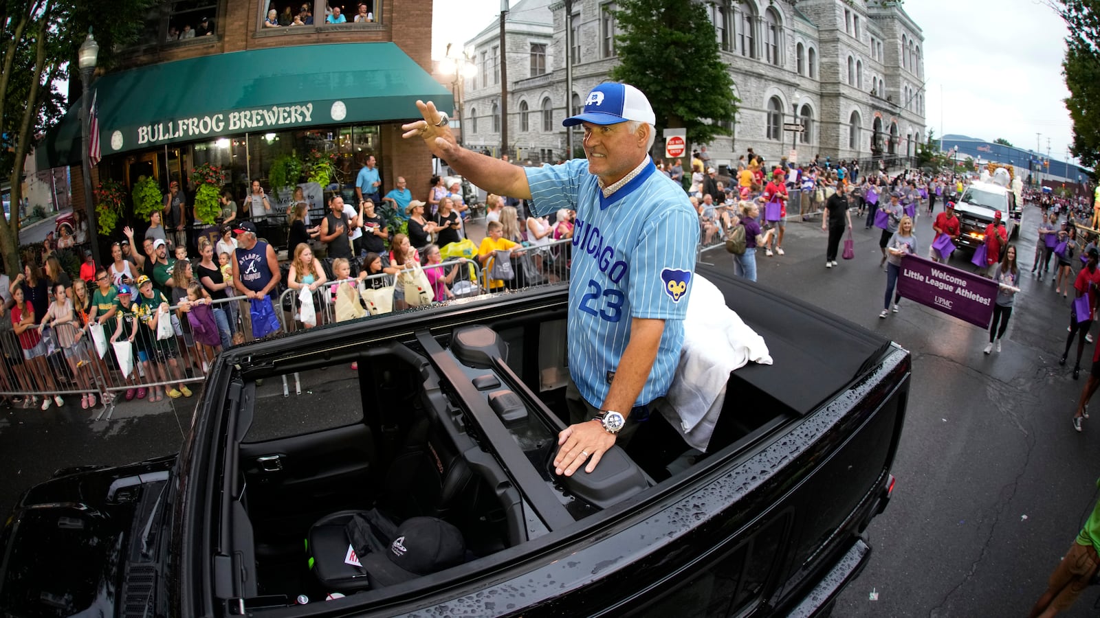 FILE - Baseball Hall of Fame infielder Ryne Sandberg, the Grand Marshall of this year's Little League Grand Slam Parade, rides through downtown Williamsport, Pa., Monday, Aug. 14, 2023. (AP Photo/Gene J. Puskar,File)