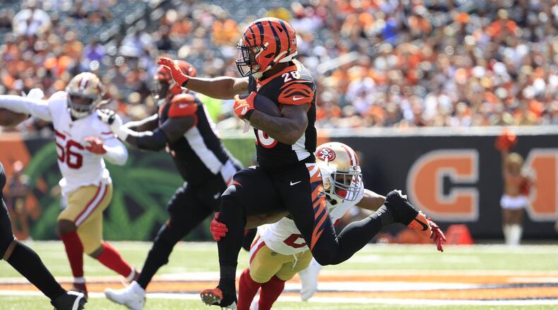CINCINNATI, OHIO - SEPTEMBER 15: Joe Mixon #28 of the Cincinnati Bengals runs with the ball while defended by K’Waun Williams #24 of the San Francisco 49ers at Paul Brown Stadium on September 15, 2019 in Cincinnati, Ohio. (Photo by Andy Lyons/Getty Images)