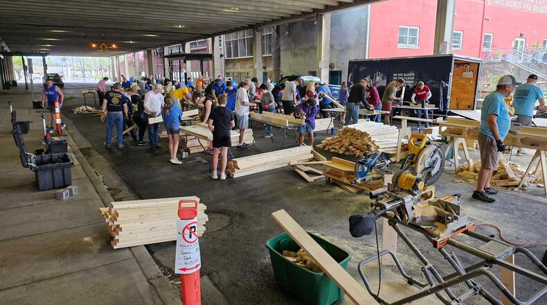 Rotary District 6670 members are gearing up for an impactful Rotary Day of Service scheduled for Saturday, April 13 at Hamilton County Fairgrounds, 7801 Anthony Wayne Ave., Cincinnati. The District has joined with the Butler County chapter of Sleep in Heavenly Peace (SHP), a non-profit organization dedicated to providing beds for children aged 3-17. Pictured, Hamilton and West Chester/Liberty Rotary Clubs held a bed build day April 15, 2023 for Sleep in Heavenly Peace. Sixty beds were built with the help of members from the Hamilton High School Football Team. CONTRIBUTED