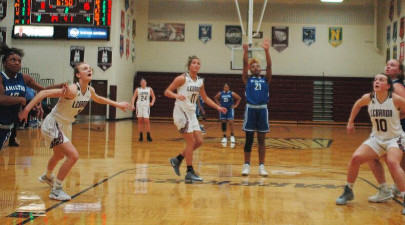 Hamilton’s CiCi Riggins shoots a free throw as Lebanon’s Molly Lane (4), Ashley West (11) and Isabella Dunn (10) do some boxing out Monday night at Lebanon. Visiting Big Blue won 52-42. RICK CASSANO/STAFF