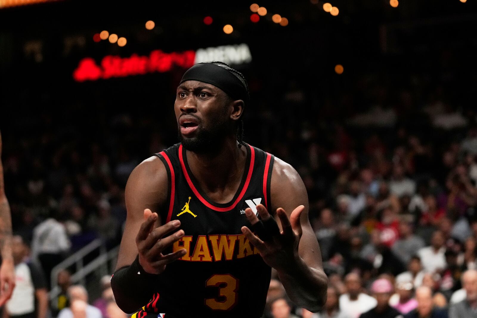 Atlanta Hawks guard Caris LeVert (3) reacts to a referee in the first half of an NBA play-in tournament basketball game against the Miami Heat, Friday, April 18, 2025, in Atlanta. (AP Photo/Brynn Anderson)