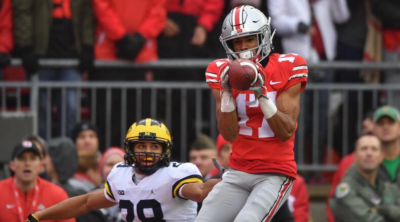 COLUMBUS, OH - NOVEMBER 24: Chris Olave #17 of the Ohio State Buckeyes catches a 24-yard touchdown pass in the second quarter in front of Brandon Watson #28 of the Michigan Wolverines at Ohio Stadium on November 24, 2018 in Columbus, Ohio. (Photo by Jamie Sabau/Getty Images)
