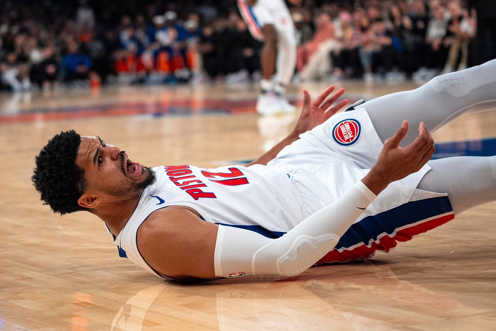 Detroit Pistons forward Tobias Harris (12) reacts as he falls to the floor during the first half of Game 2 of an NBA basketball first-round playoff series against the New York Knicks, Monday, April 21, 2025, in New York. (AP Photo/Angelina Katsanis)