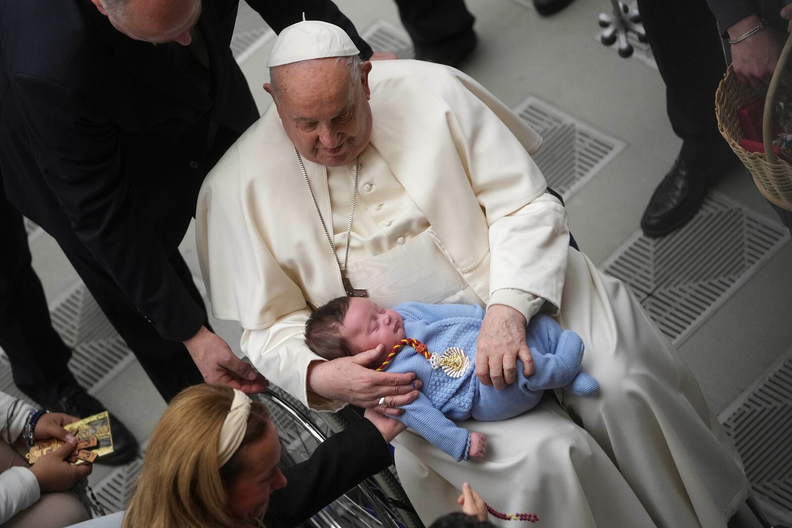 FILE - Pope Francis holds a baby as he leaves at the end of his weekly general audience in the Paul VI Hall, at the Vatican, Wednesday, Jan. 29, 2025. (AP Photo/Alessandra Tarantino, file)