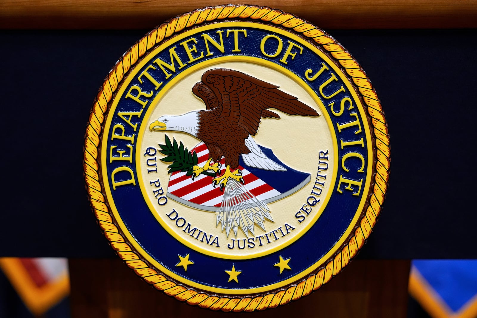 FILE - The U.S. Department of Justice logo is seen on a podium before a press conference with Attorney General Pam Bondi, Tuesday, May 6, 2025, at the Justice Department in Washington. (AP Photo/Julia Demaree Nikhinson, file)