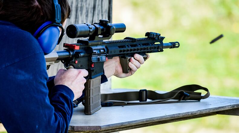 A patron fires an AR-15 style rifle at Lake Bailee recreational park and gun range Tuesday, May 1 in St. Clair Township. NICK GRAHAM/STAFF