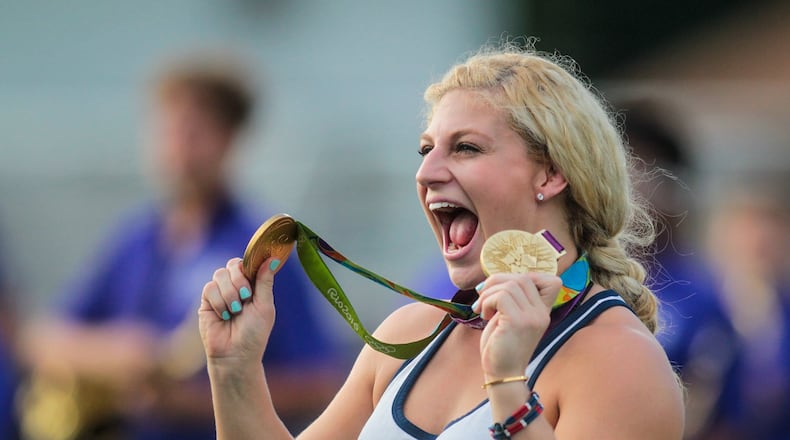 Kayla Harrison, two-time Olympic gold medalist in judo, takes the field with her gold medals before the Middletown High School football game Sept. 9, 2016 at Barnitz Stadium in Middletown. She's 7-0 in professional fights and returns to the ring Nov. 20, she announced. NICK GRAHAM/STAFF