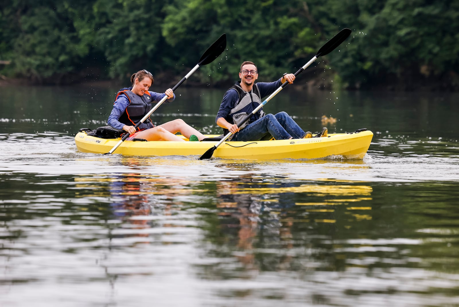 Jacob Stone-Welch and and Lauren Nelson were part of a group of about 20 people canoed and kayaked on the Great Miami River during a "Paddle to Work Day" event Friday, June 23, 2023 in Hamilton. The outing was a collaborative effort between the city, The YMCA and the Great Miami Rowing Center. The groups took off from YMCA Camp Campbell Gard and paddled to the Great Miami Rowing Center dock near the High Main Bridge. NICK GRAHAM/STAFF