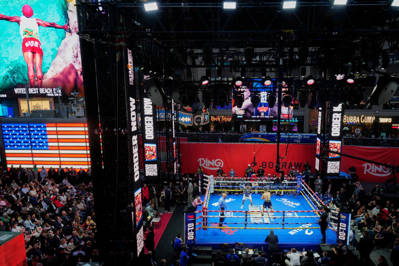 Fans watch Teofimo Lopez and Arnold Barboza Jr. fight during a super lightweight boxing match in Times Square Friday, May 2, 2025, in New York. (AP Photo/Frank Franklin II)