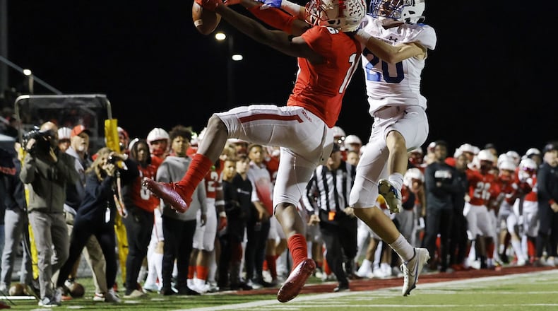 Fairfield's Noah King (left) battles St. Xavier's A.J. Martin for the ball during Friday's Division I, Region 4 playoff game at Fairfield. Nick Graham/STAFF