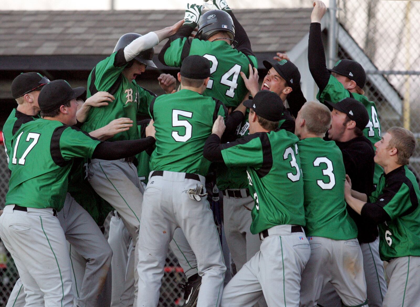 Badin’s Brett McKinney (24) jumps into his teammates’ arms after hitting a home run in the 12th inning against Talawanda in Oxford on March 30, 2009. CONTRIBUTED PHOTO BY E.L. HUBBARD