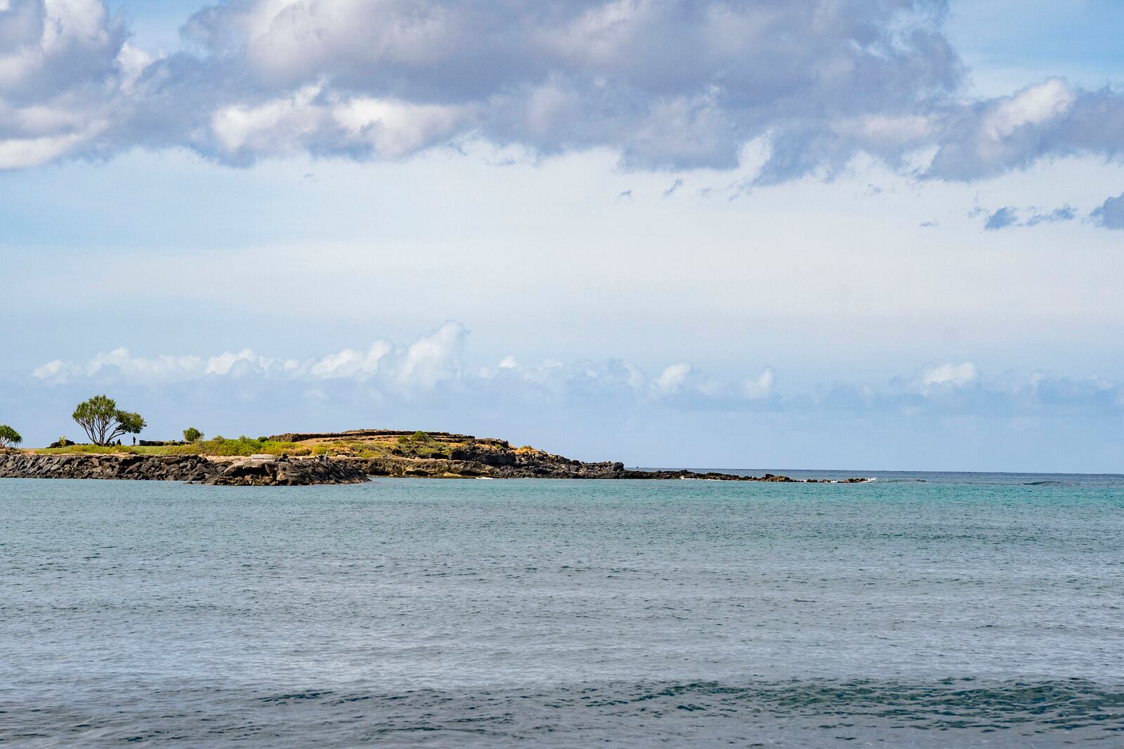A view of Kaneʻilio, a temple near Pokai Bay that cultural practitioner Glen Kila believes is spiritually connected to the nearby petroglyphs carved into the rock along the shoreline, July 22, 2025, in Waianae, Hawaii. (AP Photo/Mengshin Lin)
