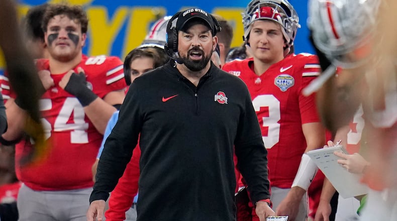 FILE - Ohio State head coach Ryan Day, center, reacts on the sideline during the second half of the Cotton Bowl NCAA college football game against Missouri, Dec. 29, 2023, in Arlington, Texas. A person with direct knowledge of the move says Michigan is finalizing a deal hire running backs coach Tony Alford. The person spoke Wednesday, March 13, 2024 to The Associated Press on condition of anonymity because contract details and university approval were still being worked out. Wolverines coach Sherrone Moore pulled off a bold move in building his first staff after Jim Harbaugh's departure, adding one of Ryan Day's top assistants at Ohio State. Day hired Alford away from Notre Dame in 2015 as running backs and assistant head coach, promoting him to run game coordinator a little more than a year ago. (AP Photo/Julio Cortez, File)