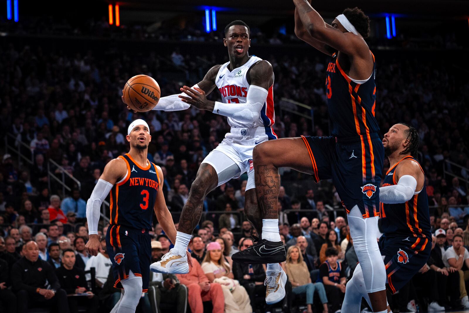Detroit Pistons guard Dennis Schroder, center, leaps to pass the ball during the second half of Game 2 of an NBA basketball first-round playoff series against the New York Knicks, Monday, April 21, 2025, in New York. (AP Photo/Angelina Katsanis)