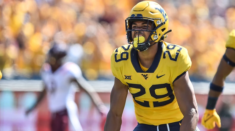 West Virginia safety Sean Mahone (29) reacts after making a play against Virginia Tech during the first half of an NCAA college football game in Morgantown, W.Va., Saturday, Sep. 18, 2021. (AP Photo/William Wotring)