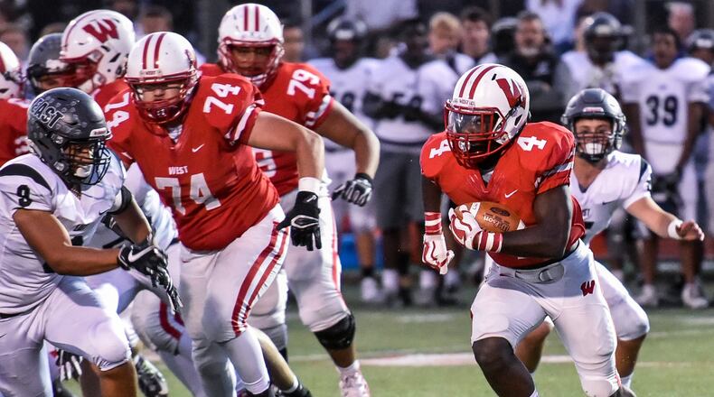 Lakota West’s David Afari carries the ball during their game against visiting Lakota East on Sept. 29, 2017. East won 35-0. NICK GRAHAM/STAFF