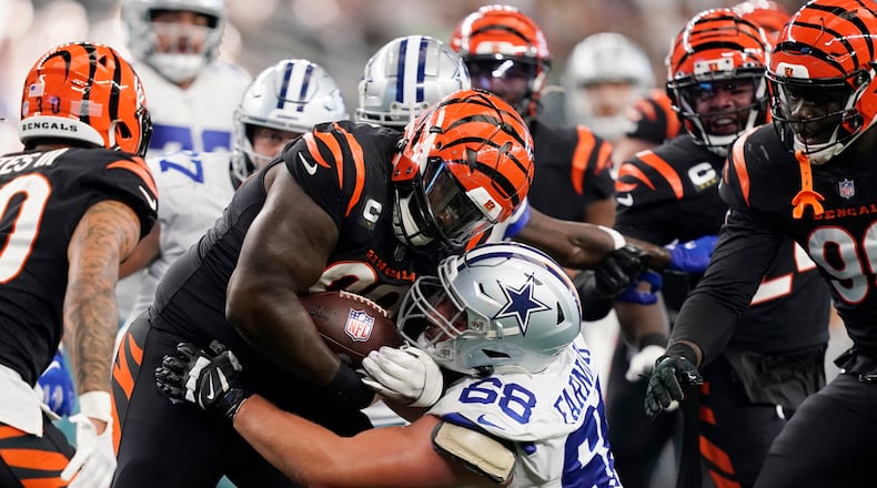 Cincinnati Bengals defensive tackle DJ Reader (98) advances the ball after a fumble recovery as Dallas Cowboys guard Matt Farniok (68) makes the stop during the second half of an NFL football game Sunday, Sept. 18, 2022, in Arlington, Tx. (AP Photo/Tony Gutierrez)