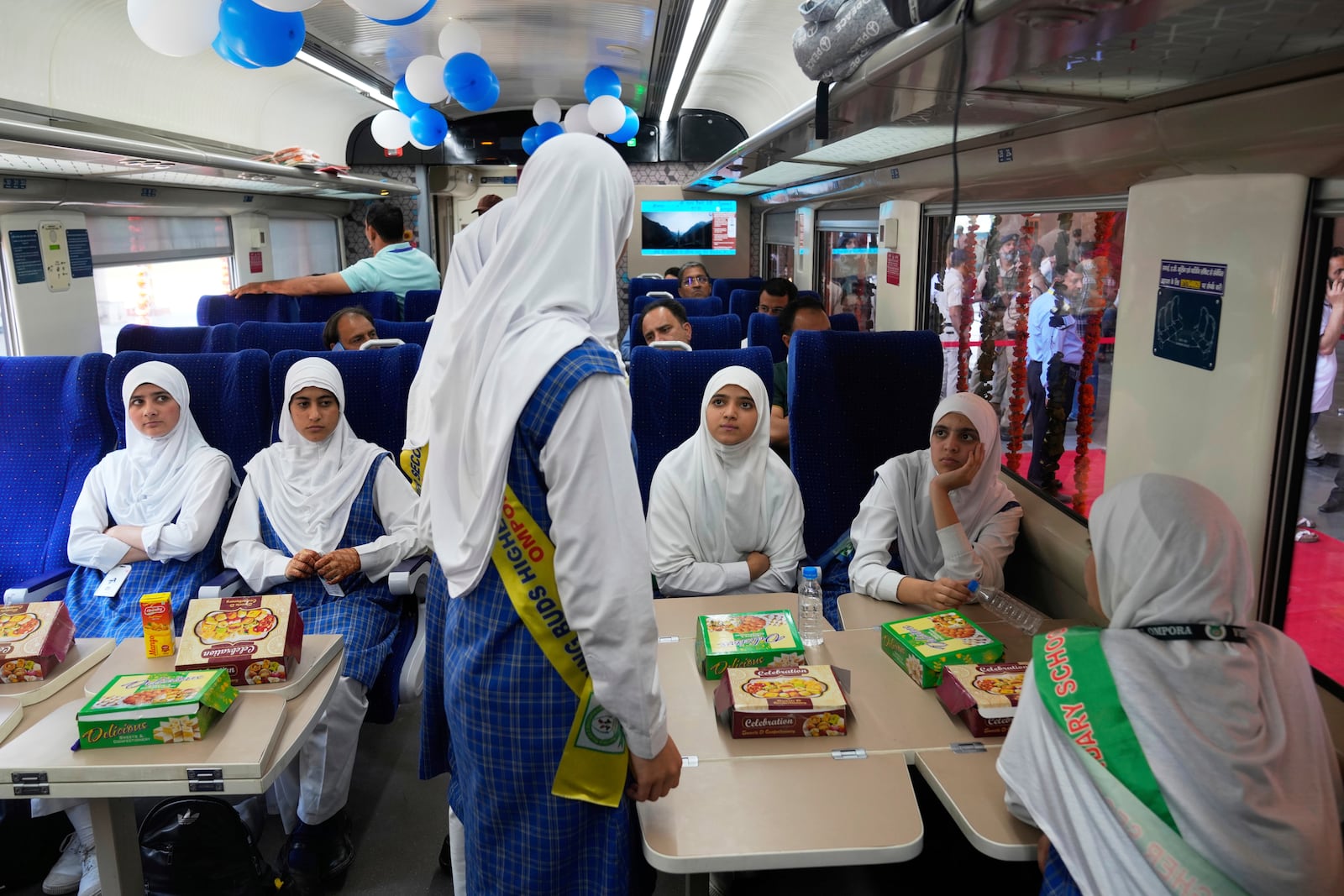 passengers get refreshments inside Vande Bharat Express train which is soon to be inaugurated to run between Srinagar and Katra, in Srinagar, Indian controlled Kashmir, Friday, June 6, 2025. (AP Photo/Dar Yasin)