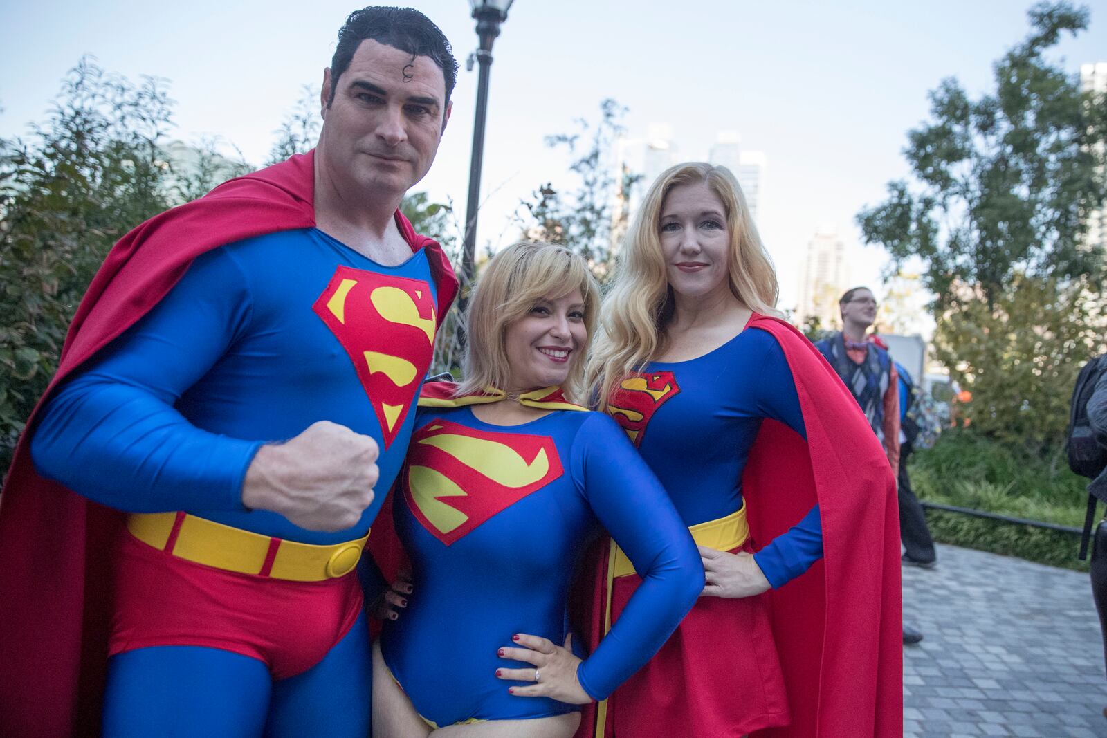 FILE - Superman fans Michael Byrnes, left, Frances Tirado, center, and Amy Byrnes pose for a photo on their way to Comic Con, Friday, Oct. 7, 2016, in New York. (AP Photo/Mary Altaffer, file)