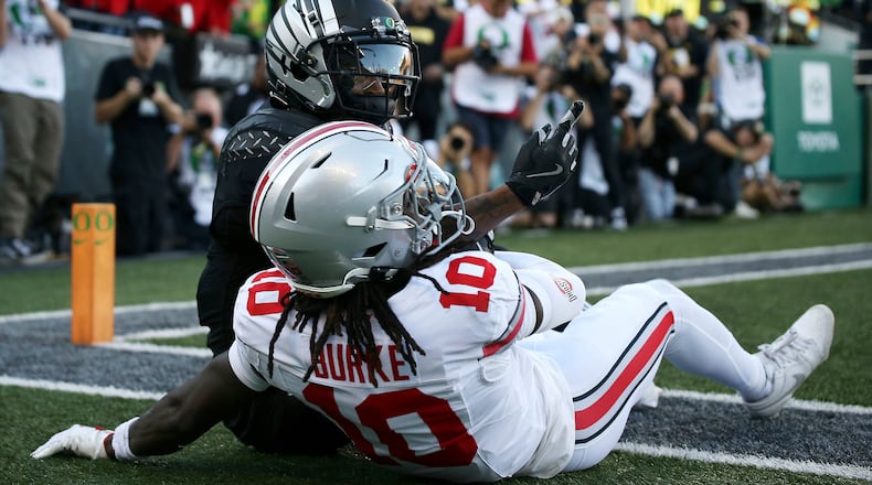 Oregon wide receiver Evan Stewart, top, celebrates after a touchdown against Ohio State cornerback Denzel Burke (10) during an NCAA college football game, Saturday, Oct. 12, 2024, in Eugene, Ore. (AP Photo/Lydia Ely)