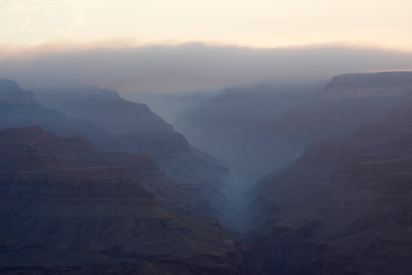 Smoke from the Dragon Bravo Fire moves over the Grand Canyon from the North Rim Tuesday, July 15, 2025, in Grand Canyon National Park, Ariz. (AP Photo/Ross D. Franklin)