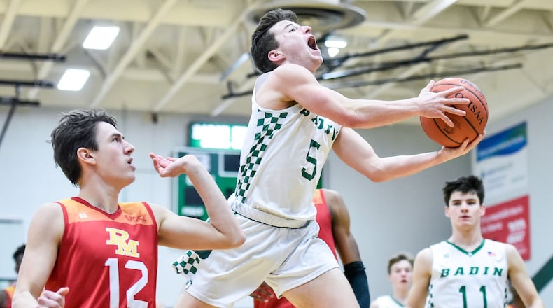Badin’s Donovan Watkins puts up a shot defended by Purcell Marian’s Jared Baldock during Friday night’s game at Mulcahey Gym in Hamilton. Purcell won 64-52. NICK GRAHAM/STAFF