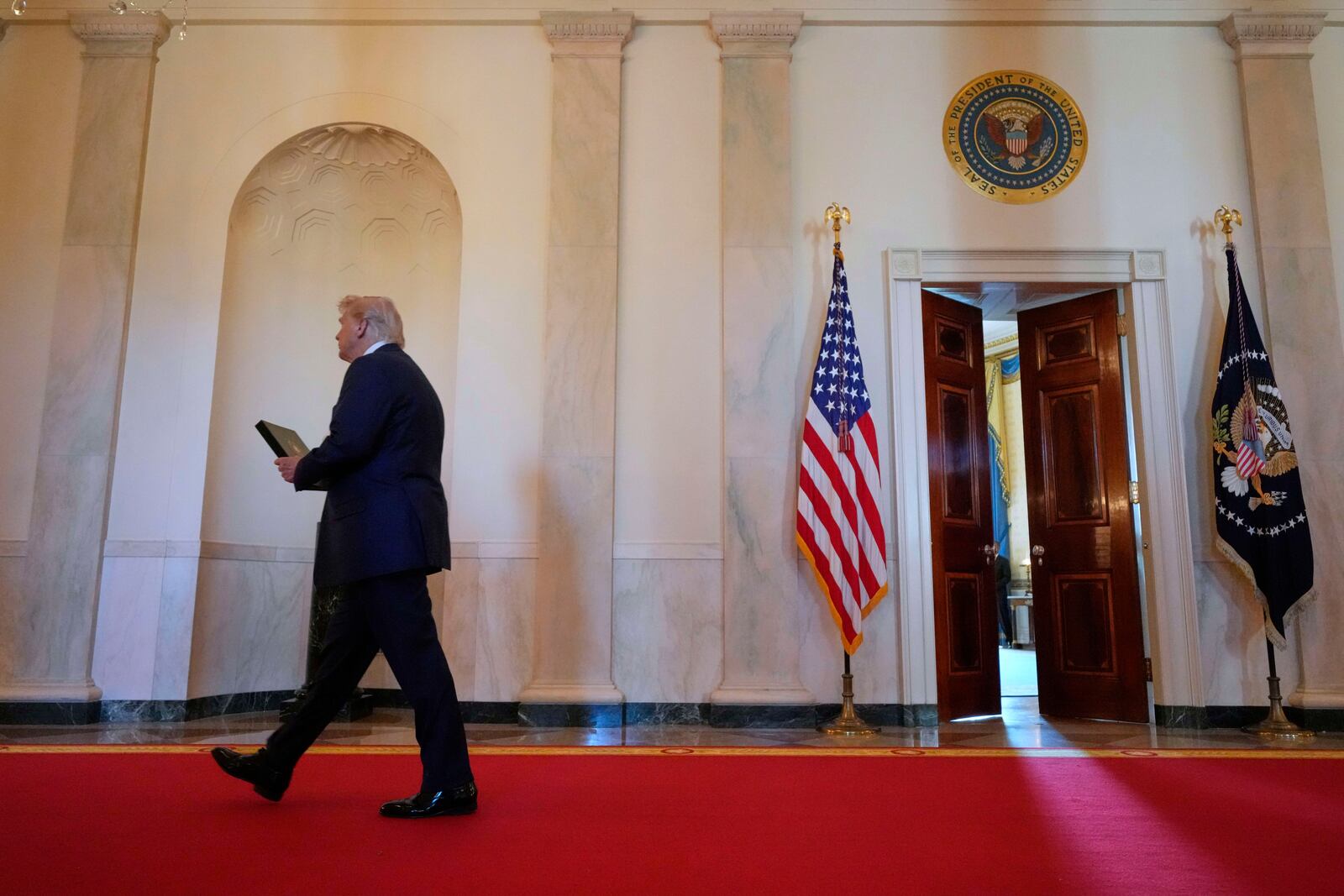 President Donald Trump arrives to speak at the Commander-in-Chief trophy presentation to the Navy Midshipman football team in the East Room of the White House, Tuesday, April 15, 2025, in Washington. (AP Photo/Alex Brandon)