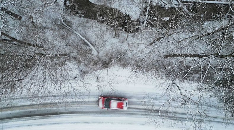A car drives on Elk Creek Road as snow falls in Madison Twp. Sunday, Jan. 5, 2025. NICK GRAHAM/STAFF