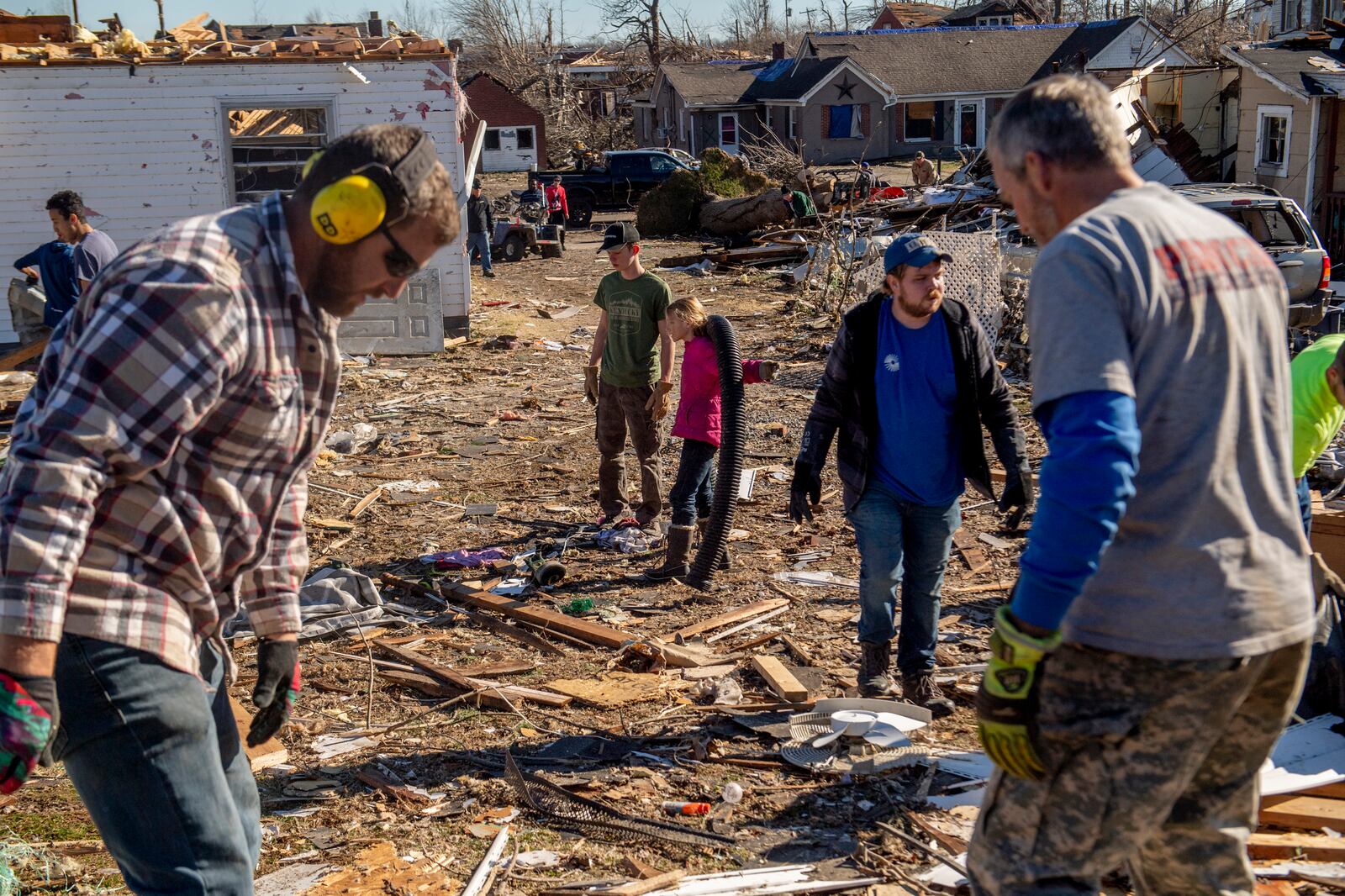 Volunteers help with the cleanup efforts in Mayfield, Ky. on Monday, Dec. 13, 2021, after a tornado swept across the region. Determining how many people died in the tornadoes that ravaged the central U.S. on Friday has been a challenging task so far, with estimates fluctuating as search teams continue to spread out amid vast fields of rubble in an effort to rescue the living and account for the dead.(Johnny Milano/The New York Times)