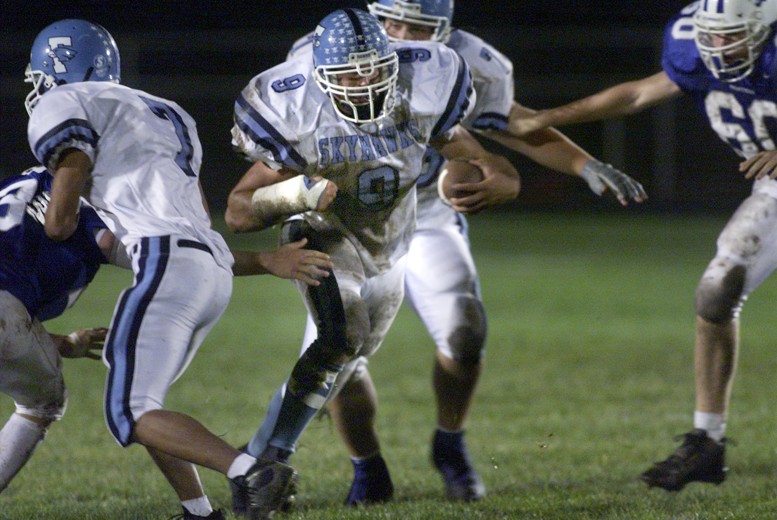 Fairborn's Clayton Mullins moves the ball for the Skyhawks against Springboro's defense during their game in 2003. TY GREENLEES/STAFF PHOTO