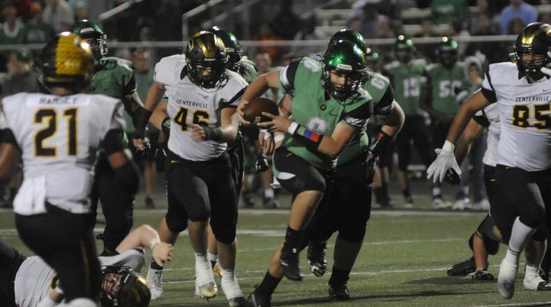Northmont QB Miles Johnson is pursued by Centerville’s Dom Ramsey (21), Jake Snead (45) and Jevon Henderson. Northmont defeated visiting and previously unbeaten Centerville 21-14 in a Week 8 GWOC crossover high school football game on Friday, Oct. 13, 2017. MARC PENDLETON / STAFF