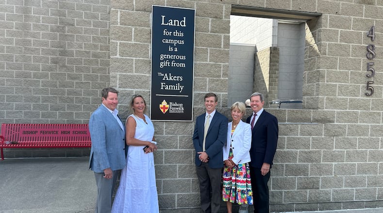 The Akers family was honored Friday morning for donating 66 aces that were used to build Fenwick High School that opened 20 years ago. The school unveiled a plaque near the entrance. From left: Bill Akers, Debby Akers, Drew Akers, Jody Akers and Jim Akers. RICK McCRABB/CONTRIBUTING REPORTER