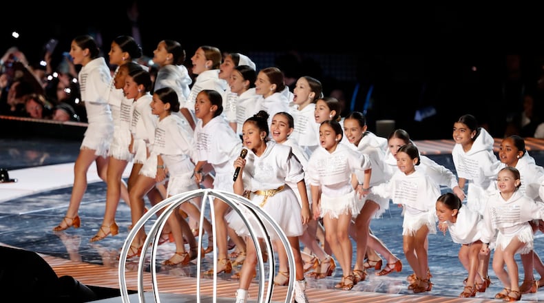 FILE - Emme Maribel Muñiz, daughter of singer Jennifer Lopez, performs with other children by a cage during the halftime show of the NFL Super Bowl 54 football game in Miami Gardens, Fla, on Feb. 2, 2020. (AP Photo/Tyler Kaufman, File)
