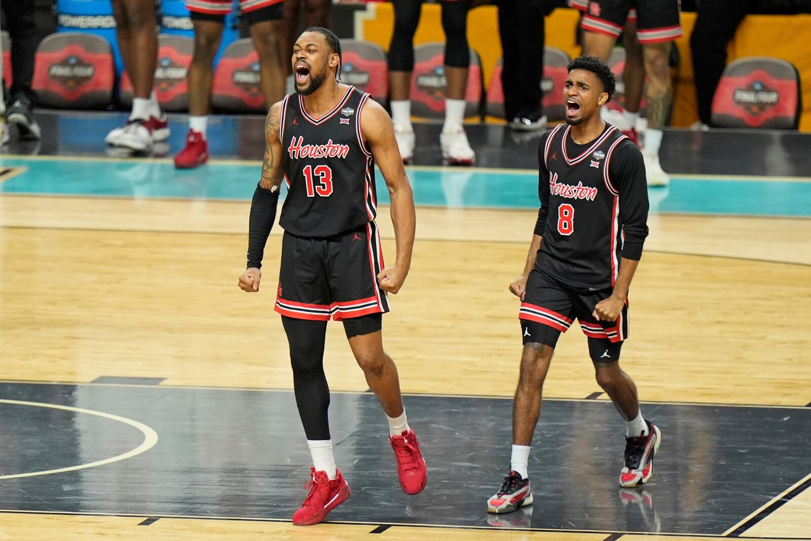 Houston's J'Wan Roberts (13) and Mylik Wilson (8) celebrate against Duke during the second half in the national semifinals at the Final Four of the NCAA college basketball tournament, Saturday, April 5, 2025, in San Antonio. (AP Photo/Stephanie Scarbrough)
