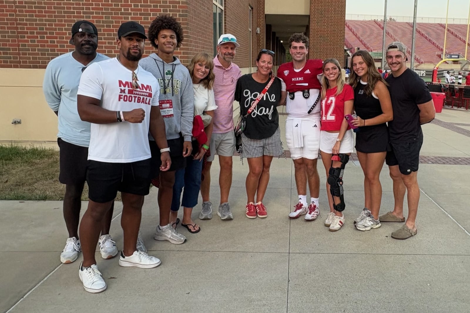 Miam University quarterback Henry Henson, who threw for 208 yards and two touchdowns Saturday to lead Miami to 38-0 victory over Lindenwood at Yager Stadium, met with his friends and family after the game, especially his dad Brett (white cap) and his mom Ashley, who is standing next to him in a dark shirt. TOM ARCHDEACON / CONTRIBUTED PHOTO
