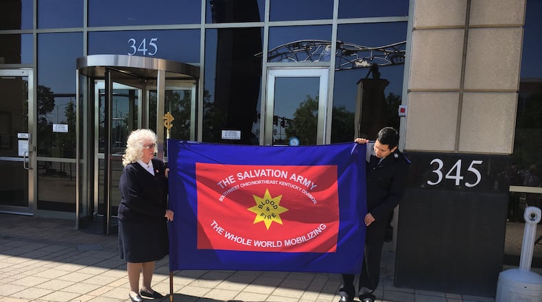 Joanie Wilson and Joel Monasterio hold the Salvation Army’s flag for 2017. WAYNE BAKER/STAFF