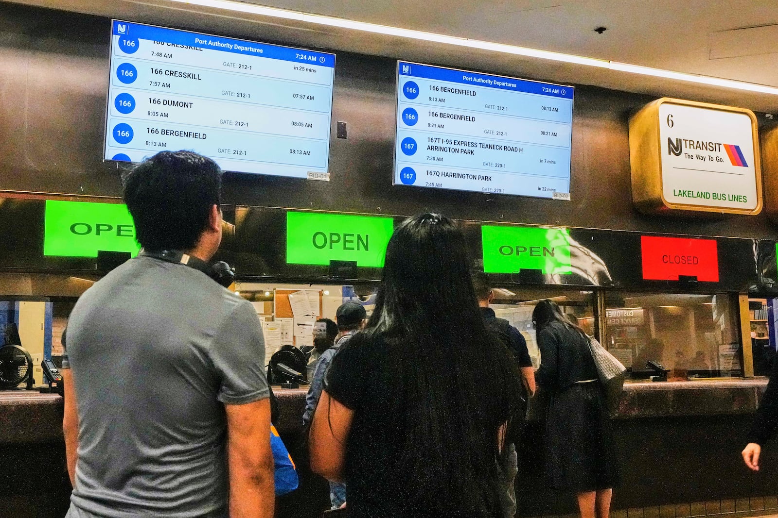Morning commuters at NJ Transit bus ticketing windows in the Port Authority Bus Terminal, in New York, Friday, May 16, 2025. (AP Photo/Richard Drew)