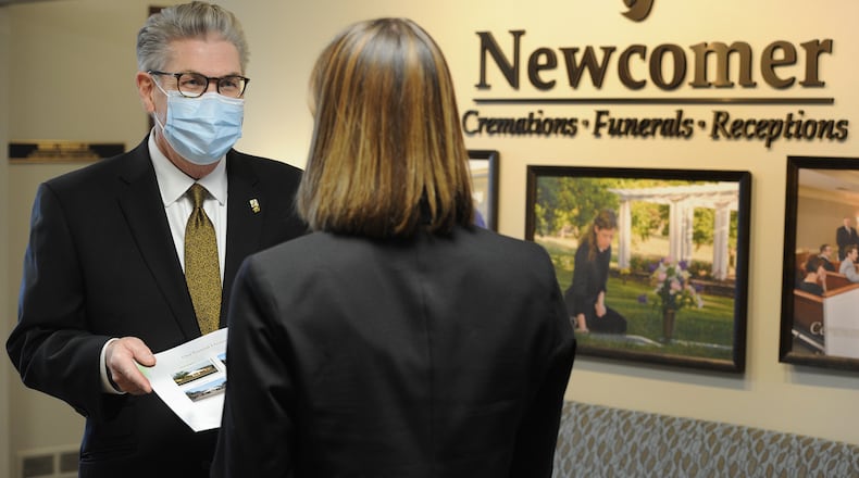 In this file photo, Jed J. Dunnichay, Funeral Director for Newcomer, talks with a potential client Friday, Dec. 18, 2020 at the Newcomer Cremations, Funerals and Receptions location in Centerville. MARSHALL GORBY\STAFF